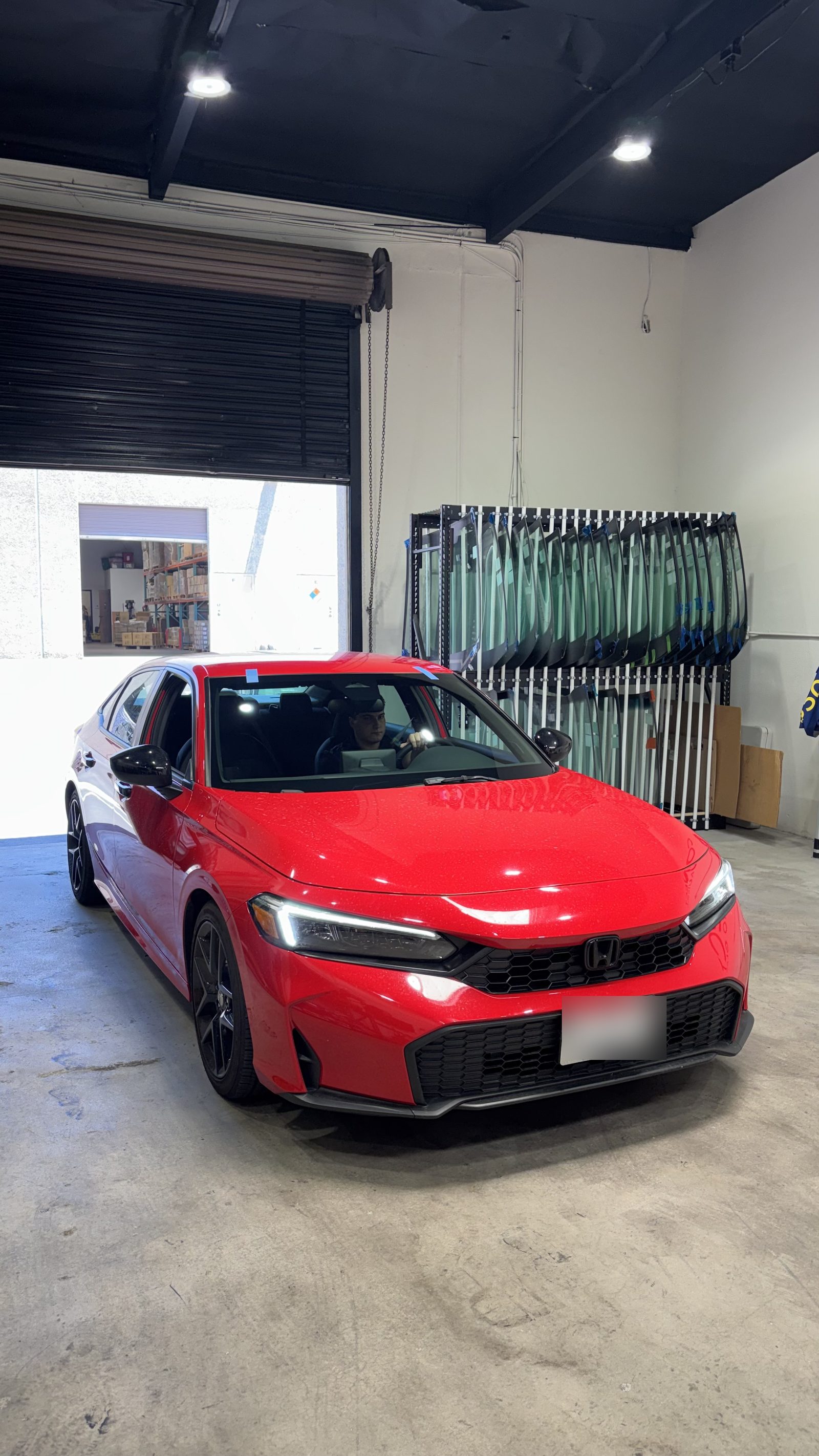 A Honda Civic Si in the Connect Auto Glass shop