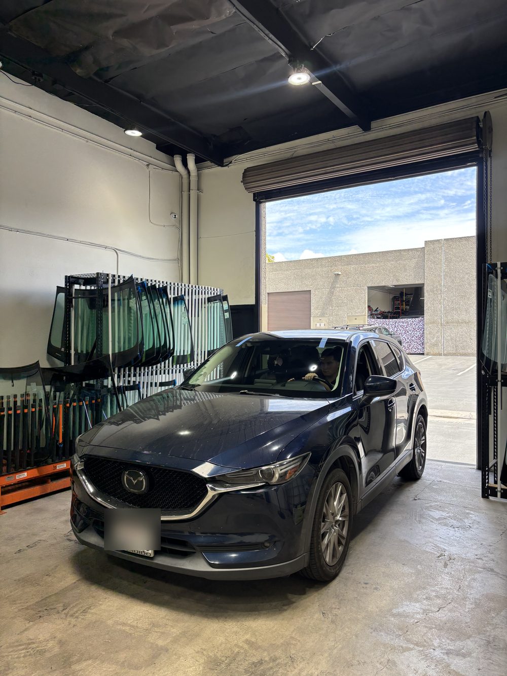 A Mazda CX-5 at the open shop door at Connect Auto Glass