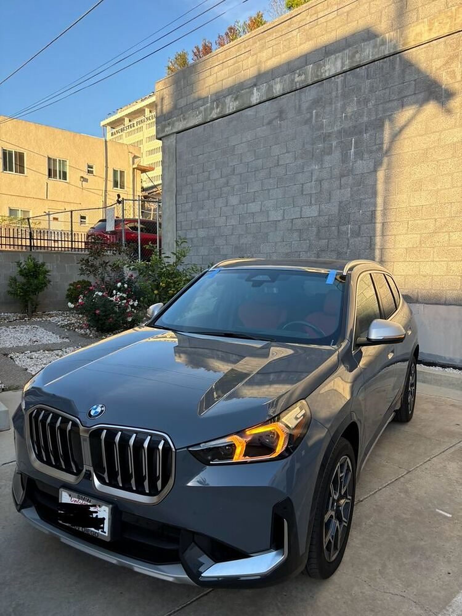A BMW X1 outside the Connect Auto Glass shop in Miramar